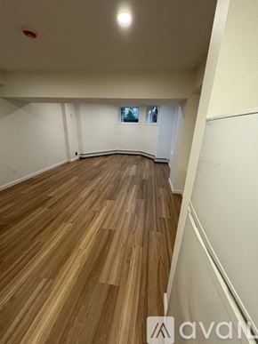 Boston apartment for rent - A room with wooden flooring and white walls.