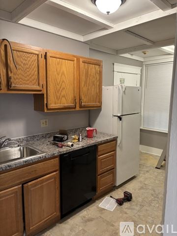 Worcester apartment for rent - A kitchen with wooden cabinets and a white refrigerator.
