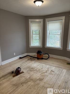 Worcester apartment for rent - A room with wooden flooring and two windows.