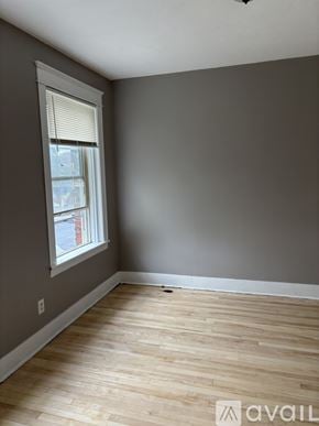 Worcester apartment for rent - A room with wooden flooring and a window with blinds.