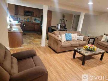 Vine Grove apartment for rent - A living room with brown furniture and a wooden floor.