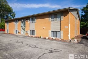 Rossford apartment for rent - A building with a parking lot in front of it.
