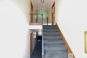 Rossford apartment for rent - A staircase with a carpeted runner and wooden handrail.