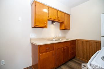 Rossford apartment for rent - A kitchen with wooden cabinets and a white countertop.
