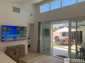 Huntington Beach apartment for rent - A living room with a large flat screen TV mounted on the wall.