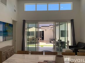 Huntington Beach apartment for rent - A modern dining room with a large table and chairs.