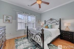 Myrtle Beach house for rent - A bedroom with a bed, dresser, and window with curtains.