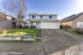 Beaverton house for rent - A two-story house with a garage and a front porch.