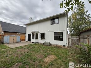 Beaverton house for rent - A house with a white exterior and a brown roof is available for rent.