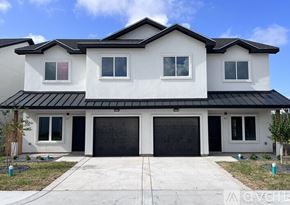 Edinburg apartment for rent - A modern two-story house with a black roof and white walls.