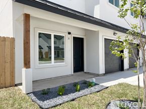 Edinburg townhouse for rent - A modern house with a white exterior and a black roof.