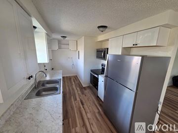 Medford apartment for rent - A kitchen with a refrigerator, sink, and cabinets.