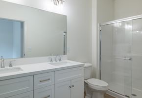 Carlisle apartment for rent - A white bathroom with a toilet, sink, and mirror.