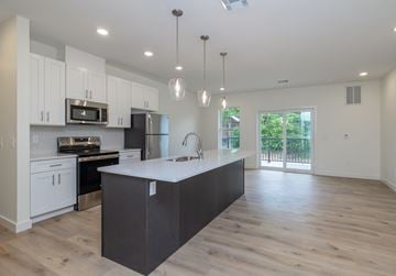 Carlisle apartment for rent - A modern kitchen with a large island and wooden floors.