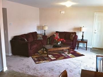 Middletown apartment for rent - A living room with a red couch and a coffee table.