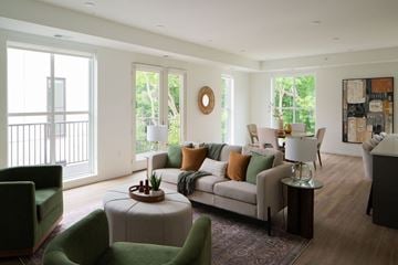 Excelsior apartment for rent - A living room with a green chair and a white couch.