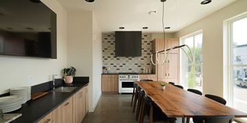 Excelsior apartment for rent - A kitchen with a long wooden table and chairs.