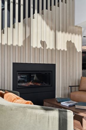 Excelsior apartment for rent - A modern living room with a fireplace and a chair.