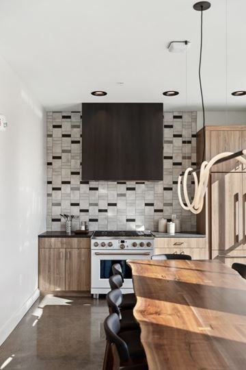 Excelsior apartment for rent - A modern kitchen with a white stove top oven and a black backsplash.
