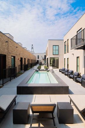 Excelsior apartment for rent - A pool surrounded by black and white furniture.