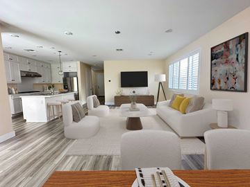 San Pedro house for rent - A modern living room with a white couch and a wooden coffee table.