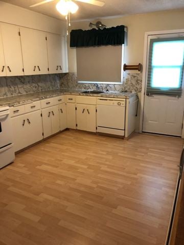 Swift Current apartment for rent - A kitchen with white appliances and wooden floors.