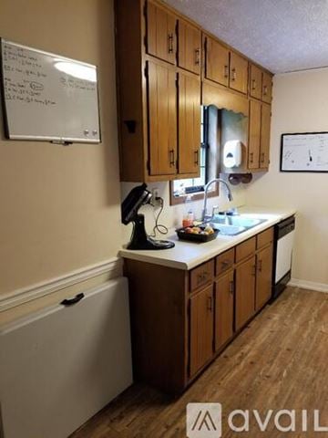 Lawrenceville apartment for rent - A kitchen with wooden cabinets and a whiteboard on the wall.