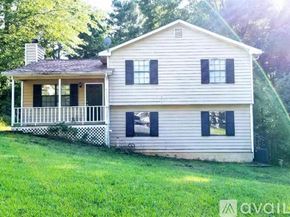 Lawrenceville apartment for rent - A two-story house with a porch and a chimney.