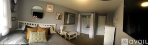 Anacortes apartment for rent - A bedroom with a bed, nightstand, and a mirror on the wall.