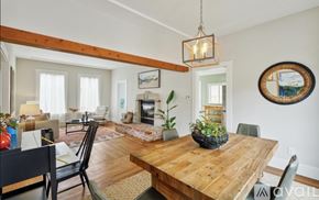 Oakland apartment for rent - A dining room with a wooden table and chairs.