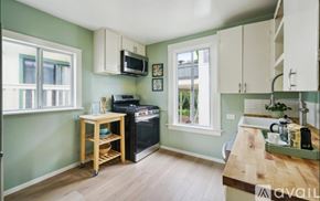 Oakland apartment for rent - A kitchen with a wooden table and a black oven.