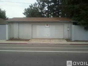 Visalia apartment for rent - A garage with a white door and a brown roof.