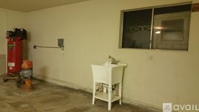 Visalia apartment for rent - A white sink is in a room with a red fire extinguisher.