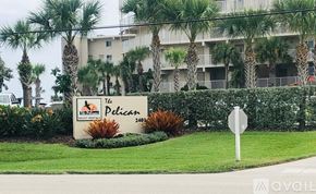 New Smyrna Beach condo for rent - The sign in front of the building says The Pelican.