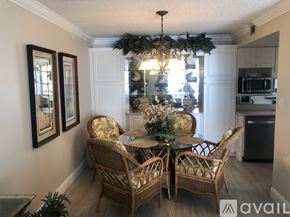 New Smyrna Beach condo for rent - A dining room with a table set for four and a chandelier.