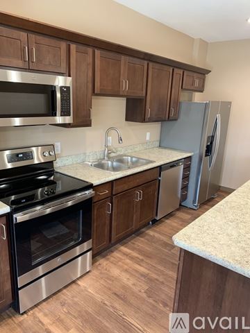 Helena apartment for rent - A kitchen with wooden cabinets and stainless steel appliances.