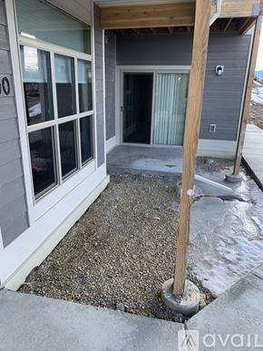 Helena apartment for rent - A house with a grey exterior and a white door and window.