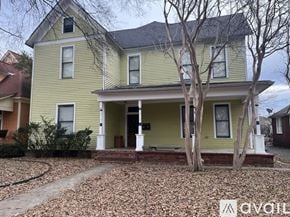 North Little Rock apartment for rent - A yellow house with a tree in front.