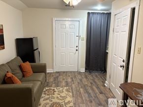 North Little Rock apartment for rent - A living room with a couch, a television, and a rug.