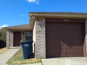 Fort Worth apartment for rent - A brown garage door with the number 8126 on it.