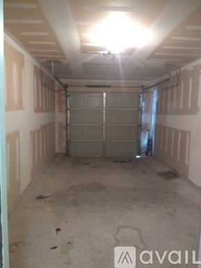 Fort Worth apartment for rent - A garage with a closed door and a light on the ceiling.