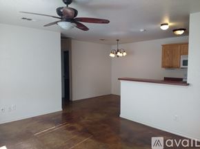 Fort Worth apartment for rent - A room with a ceiling fan and a bar area.