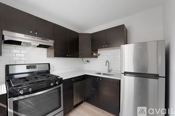Chicago apartment for rent - A modern kitchen with a stainless steel refrigerator, oven, and sink.
