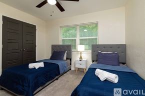 Lake Worth house for rent - A bedroom with two beds and a ceiling fan.