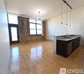 Chicago apartment for rent - A kitchen area with a brick wall and wooden flooring.