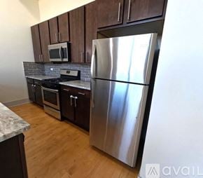 Chicago apartment for rent - A kitchen with a stainless steel refrigerator, microwave, oven, and dishwasher.