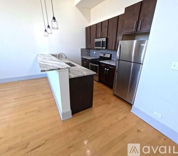 Chicago apartment for rent - A kitchen with wooden cabinets and a marble island.