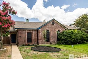 Euless house for rent - A house with a brick facade and a green lawn in front.