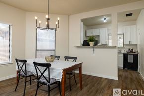 Euless house for rent - A dining room with a table set for four and a kitchen area in the background.