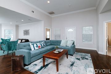 Dallas house for rent - A living room with a blue couch and a wooden coffee table.